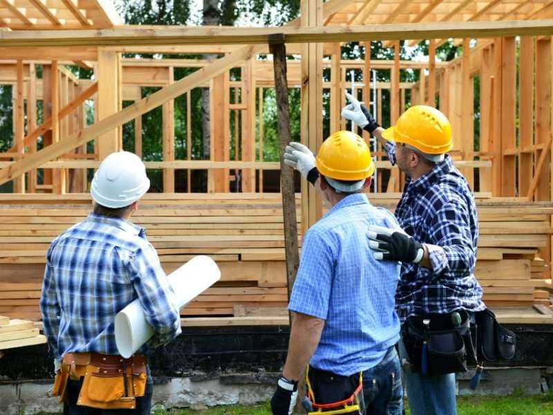 Construction crews reviewing framing changes and coordinating adjustments as the project evolves.
