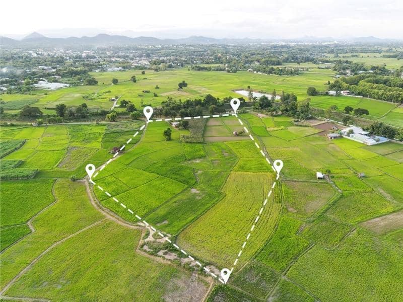 Aerial view of land parcel showing surveyed boundary lines across agricultural fields used for subdivision planning and topographic mapping analysis